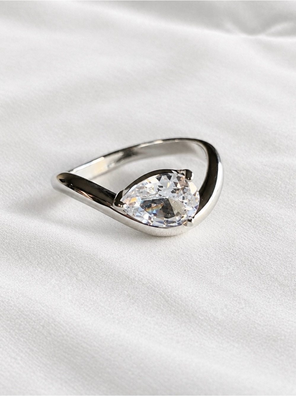 Minimalist silver wavy ring with tear drop shaped stone